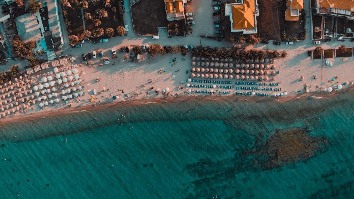 people on shore beside sea