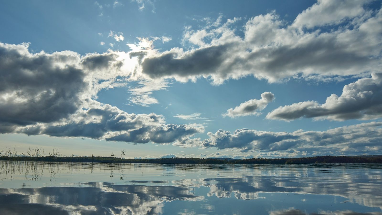 blue sky and white clouds over lake