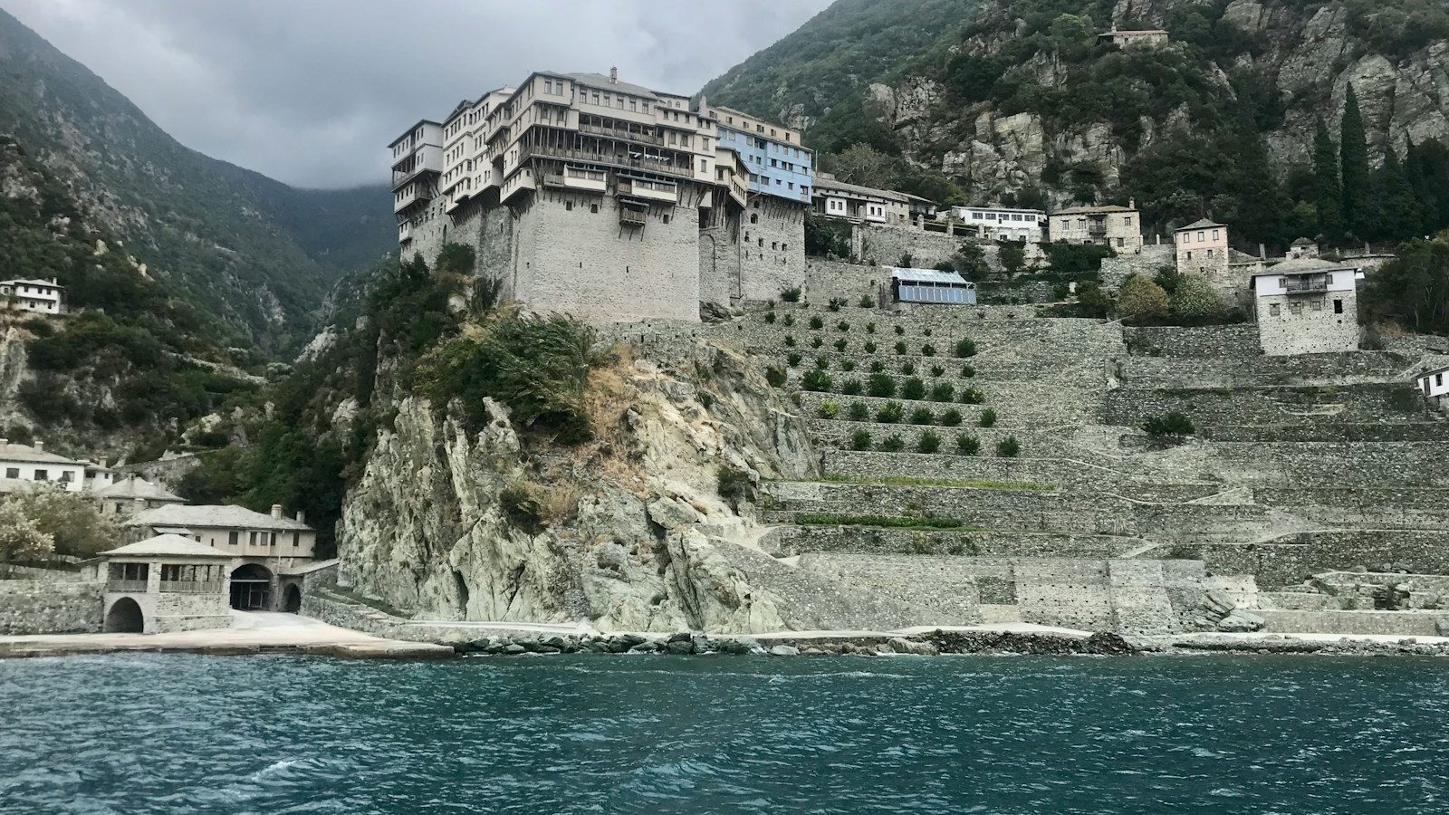 white and brown concrete building near body of water during daytime