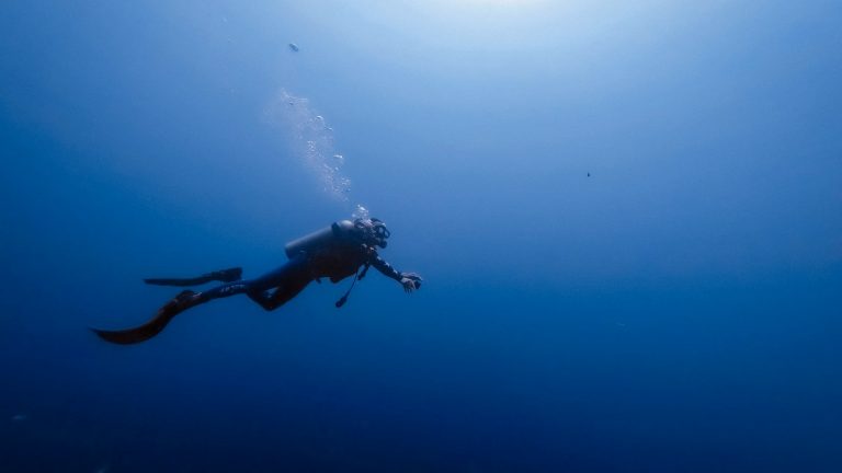 person swimming under water photography