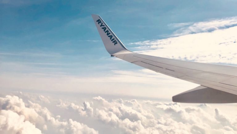 a view of the wing of an airplane in the sky