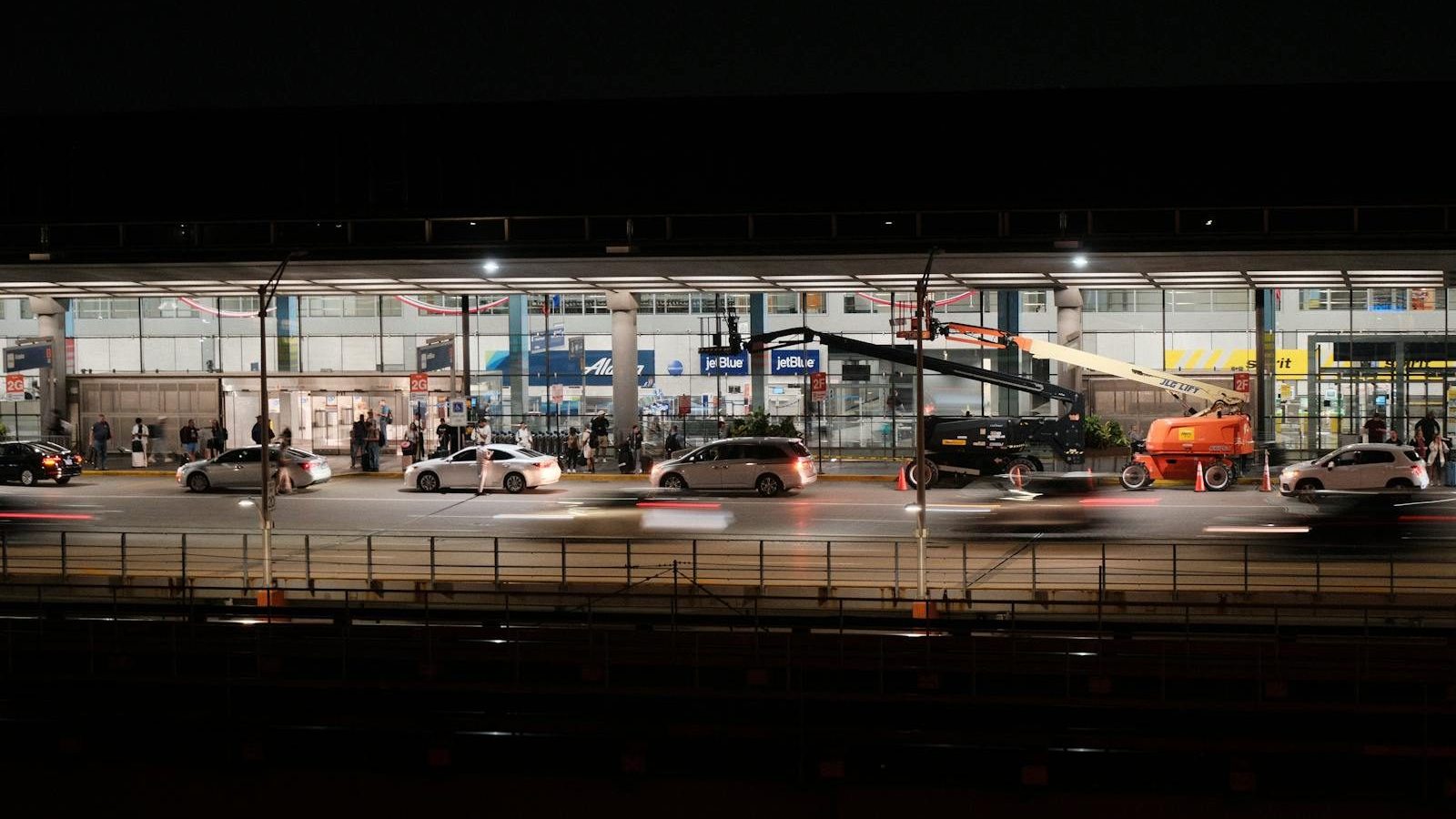 Long exposure captures bustling activity at Chicago O'Hare Airport during nighttime.